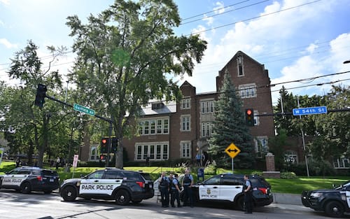 Police and first responders work at the scene of a shooting near Annunciation Church and Catholic School in Minneapolis, Minneosta, on August 27, 2025. Two children were shot dead when a gunman attacked a Minneapolis church on Wednesday, with 17 people injured, 14 of them children, police said. The gunman "began firing a rifle through the church windows towards the children sitting in the pews at the mass," Minneapolis police chief Brian O'Hara told reporters. The pupils were marking the first week of the school year when the attack occurred. (Photo by TOM BAKER / AFP)