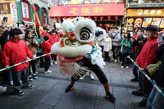 YOKOHAMA, JAPAN - FEBRUARY 10: A lion dance is performed in front of a gift shop in Yokohama China Town on February 10, 2024 in Yokohama, Japan. Lunar New Year, also known as Chinese New Year, which falls on February 10th this year, welcomes the Year of the Wood Dragon in 2024. (Photo by Takashi Aoyama/Getty Images)