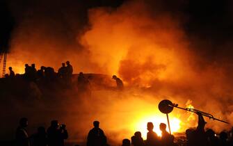 Pakistani firefighters extinguish fire caused by a Russian-made cargo plane that crashed in a fireball seconds after taking off from the Karachi's airport early November 28, 2010. The crash caused a massive blaze in the Dalmai neighbourhood, where the Pakistan Air Force and Navy have residential apartments and sensitive installations close to Jinnah International airport. The Ilyushin IL-76 aircraft had been bound for the Sudanese capital Khartoum, Civil Aviation Authority spokesman said. Police said there were injuries, but there was no immediate confirmation on casualty numbers or whether people had been hurt on the ground.   AFP PHOTO / ASIF HASSAN (Photo credit should read ASIF HASSAN/AFP via Getty Images)