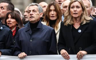 epa10971913 (L-R) Paris Mayor Anne Hidalgo, former French President Nicolas Sarkozy, his wife Italian-French singer Carla Bruni and France's National Assembly President Yael Braun-Pivet participate in a march against rising anti-Semitism, called by the presidents of French Senate and National Assembly, in Paris, France, 12 November 2023. Thousands of demonstrators marched in Paris against anti-Semitism on 12 November, as tensions have risen in the French capital, which is home to large Jewish and Muslim communities, following the 07 October attack by the militant group Hamas on Israel.Thousands of Israelis and Palestinians have died since the militant group Hamas launched an unprecedented attack on Israel from the Gaza Strip on 07 October, and the Israeli strikes on the Palestinian enclave which followed it.  EPA/MOHAMMED BADRA