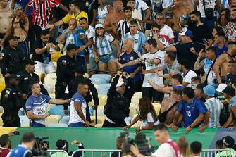 RIO DE JANEIRO, BRAZIL - NOVEMBER 21: Police officers armed with batons clash with fans as the match is delayed  due to the incidents prior to a FIFA World Cup 2026 Qualifier match between Brazil and Argentina at Maracana Stadium on November 21, 2023 in Rio de Janeiro, Brazil. (Photo by Wagner Meier/Getty Images)