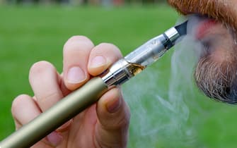 Close-up of a man vaping an electronic cigarette