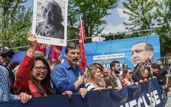 epa10601912 Erkan Bas(2-R), leader of Worker's Party of Turkey and Sera Kadigil (L), deputy of Worker's Party of Turkey walk in front of a picture of Turkish President Recep Tayyip Erdogan during a May Day celebration rally in Istanbul, Turkey, 01 May 2023. International Workers' Day is an annual holiday that takes place on 01 May and celebrates workers, their rights, achievements and contributions to society.  EPA/ERDEM SAHIN