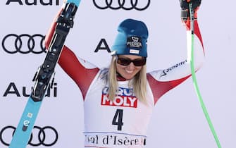 epa11032159 Third placed Cornelia Huetter of Austria celebrates on the podium for the Women's Downhill race at the FIS Alpine Skiing World Cup in Val d'Isere, France, 16 December 2023.  EPA/GUILLAUME HORCAJUELO