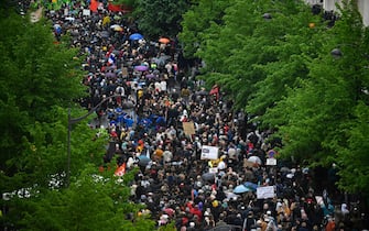 Protesters take part in a demonstration on May Day (Labour Day), to mark the international day of the workers, more than a month after the government pushed an unpopular pensions reform act through parliament, in Paris, on May 1, 2023. - Opposition parties and trade unions have urged protesters to maintain their three-month campaign against the law that will hike the retirement age to 64 from 62. (Photo by JULIEN DE ROSA / AFP) (Photo by JULIEN DE ROSA/AFP via Getty Images)