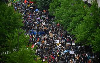 Protesters take part in a demonstration on May Day (Labour Day), to mark the international day of the workers, more than a month after the government pushed an unpopular pensions reform act through parliament, in Paris, on May 1, 2023. - Opposition parties and trade unions have urged protesters to maintain their three-month campaign against the law that will hike the retirement age to 64 from 62. (Photo by JULIEN DE ROSA / AFP) (Photo by JULIEN DE ROSA/AFP via Getty Images)