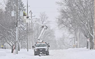 DES MOINES, IA - JANUARY 12: A power line worker makes repairs to a utility pole during blizzard conditions ahead of the Iowa Caucuses on January 12, 2024 in Des Moines, IA. (Photo by Ricky Carioti/The Washington Post via Getty Images)