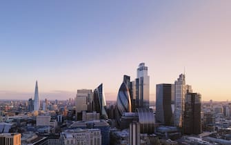 UK, London, elevated view over the city financial district skyline at sunset