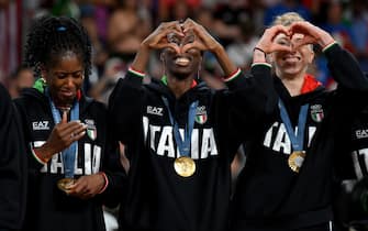 Italy's Paola Ogechi Egonu (C) and Myriam Fatime Sylla (L) celebrate on the podium after winning the Women's gold medal match between USA and Italy of the Volleyball competitions in the Paris 2024 Olympic Games, at the South Paris Arena in Paris, France, 11 August 2024. ANSA/ETTORE FERRARI