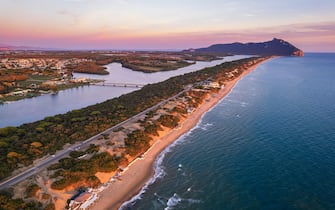 Aerial view of the lake and beach of Sabaudia with the woody mountain of Circeo in the background at dusk, Sabaudia, Tyrrhenian Sea