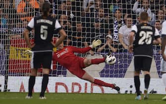 Malaga's Argentinian goalkeeper Willy Caballero saves a ball on a penalty kick during the Spanish league football match Real Madrid CF vs Malaga CF at the Santiago Bernabeu stadium in Madrid on May 8, 2013.   AFP PHOTO/ DANI POZO        (Photo credit should read DANI POZO/AFP via Getty Images)