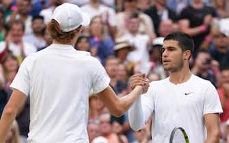 Jannik Sinner (left) shakes hands with Carlos Alcaraz after their Gentlemen's Singles fourth round match during day seven of the 2022 Wimbledon Championships at the All England Lawn Tennis and Croquet Club, Wimbledon. Picture date: Sunday July 3, 2022.