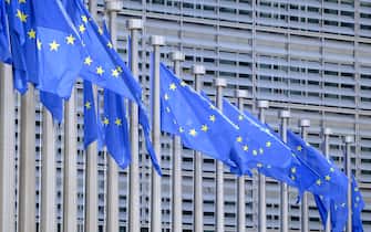 BRUSSELS, BELGIUM - JUNE 16: The EU flags flutter in the wind in front of the Berlaymont, the EU Commission headquarter on June 16, 2023 in Brussels, Belgium. The Flag of Europe, adopted on December 9, 1955, is a flag decorated with twelve five-pointed gold stars, one of the points pointing upwards, arranged at equal distance in a circle on a field of azure. It represents solidarity and union between the peoples of Europe. (Photo by Thierry Monasse/Getty Images)