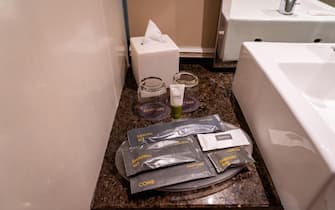 A set of packaged bathroom amenities on a granite countertop.
