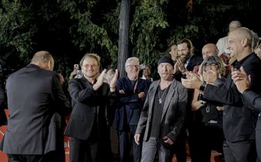 SARAJEVO, BOSNIA AND HERZEGOVINA - AUGUST 11: Bono Vox (2nd L), front man of the Irish rock band U2, arrives at the red carpet area in front of Bosnian National Theater before the premiere of the motion picture 'Kiss The Future' during the grand opening ceremony within the 29th edition of the Sarajevo Film Festival in Sarajevo, Bosnia and Herzegovina on August 11, 2023. (Photo by Samir Jordamovic/Anadolu Agency via Getty Images)