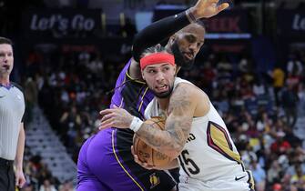 NEW ORLEANS, LOUISIANA - DECEMBER 31: Jose Alvarado #15 of the New Orleans Pelicans steals the ball from LeBron James #23 of the Los Angeles Lakers during the first half at the Smoothie King Center on December 31, 2023 in New Orleans, Louisiana. NOTE TO USER: User expressly acknowledges and agrees that, by downloading and or using this Photograph, user is consenting to the terms and conditions of the Getty Images License Agreement. (Photo by Jonathan Bachman/Getty Images)