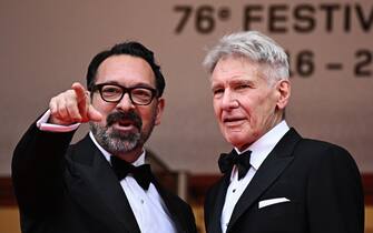 US director James Mangold (L) getsures next to US actor Harrison Ford as they arrive for the screening of the film "Indiana Jones and the Dial of Destiny" during the 76th edition of the Cannes Film Festival in Cannes, southern France, on May 18, 2023. (Photo by LOIC VENANCE / AFP) (Photo by LOIC VENANCE/AFP via Getty Images)