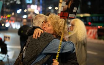 15 January 2025, Israel, Tel Aviv: Demonstrators embrace each other during a protect in front of the Israeli Defence Ministry, calling for the release of Israelis held hostage in Gaza since October 2023. The protest comes amid reports of a ceasefire deal between Israel and Hamas, which includes the release of hostages, according to officials from Hamas, the United States, and other mediators. Photo: Ilia Yefimovich/dpa (Photo by Ilia Yefimovich/picture alliance via Getty Images)