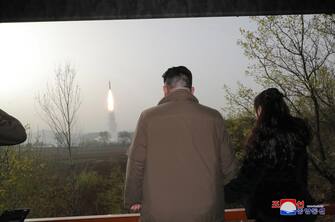 A photo released by the official North Korean Central News Agency (KCNA) shows North Korean leader Kim Jong Un (L) and his daughter Kim Ju Ae observing the test firing of a new solid-fuel Hwasong-18 intercontinental ballistic missile (ICBM) at an undisclosed location in North Korea, 13 April 2023 (Issued 14 April 2023). According to KCNA, a new-type of ICBM Hwasongpho-18 that will serve as an 'important war deterrent', was test-fired on 13 April where the first stage safely landed in the waters 10 kilometres off the Hodo Peninsula in Kumya County, South Hamgyong Province and the second stage in the waters 335 kilometres east of Orang County, North Hamgyong Province. ANSA/KCNA   EDITORIAL USE ONLY  EDITORIAL USE ONLY