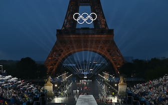 Delegations arrive on the Iena Bridge during the opening ceremony of the Paris 2024 Olympic Games in Paris on July 26, 2024, as the Eiffel Tower is seen in the background. (Photo by Fabrice COFFRINI / AFP) (Photo by FABRICE COFFRINI/AFP via Getty Images)