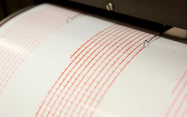 Seismograph records an earthquake on the sheet of measuring paper. Seismological device for measuring earthquakes. Seismograph machine needle drawing