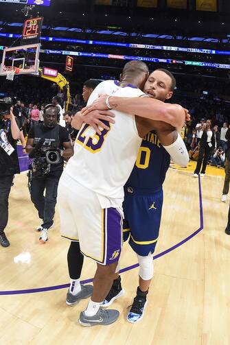 LOS ANGELES, CA - MARCH 16:  LeBron James #23 of the Los Angeles Lakers & Stephen Curry #30 of the Golden State Warriors embrace after the game on March 16, 2024 at Crypto.Com Arena in Los Angeles, California. NOTE TO USER: User expressly acknowledges and agrees that, by downloading and/or using this Photograph, user is consenting to the terms and conditions of the Getty Images License Agreement. Mandatory Copyright Notice: Copyright 2024 NBAE (Photo by Andrew D. Bernstein/NBAE via Getty Images)