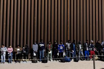 epaselect epa10620625 Migrants wait to be processed by Border Patrol agents after crossing illegally the border between the United States and Mexico, in Yuma, Arizona, USA, 10 May 2023. A significant increase in the number of migrants crossing is expected as Covid-era Title 42 policy, which allowed for a quick expulsion of illegal immigrants, is set to expire on 11 May 2023.  EPA/ETIENNE LAURENT