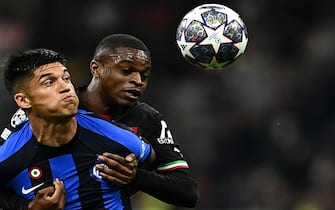 TOPSHOT - AC Milan's French defender Pierre Kalulu (C) holds back Inter Milan's Argentinian forward Joaquin Correa during the UEFA Champions League semi-final first leg football match between AC Milan and Inter Milan, on May 10, 2023 at the San Siro stadium in Milan. (Photo by GABRIEL BOUYS / AFP) (Photo by GABRIEL BOUYS/AFP via Getty Images)