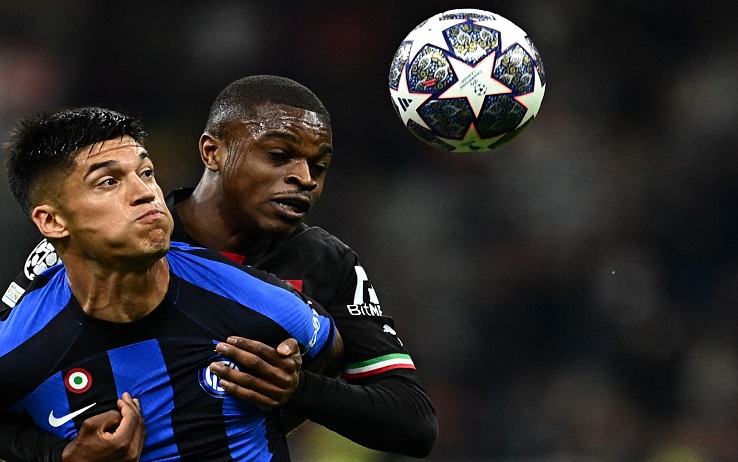 TOPSHOT - AC Milan's French defender Pierre Kalulu (C) holds back Inter Milan's Argentinian forward Joaquin Correa during the UEFA Champions League semi-final first leg football match between AC Milan and Inter Milan, on May 10, 2023 at the San Siro stadium in Milan. (Photo by GABRIEL BOUYS / AFP) (Photo by GABRIEL BOUYS/AFP via Getty Images)