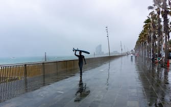 Mandatory Credit: Photo by David Canales/SOPA Images/Shutterstock (14413781e)
A surfer walks along Barceloneta and protects herself from the rain with the surfboard on her head during the Storm Nelson. View of Barceloneta beach in Barcelona, Spain during the Storm Nelson, which has kept ten Spanish communities on yellow alert during this Holy Week due to rain, wind or snow.
Storm Nelson in Barcelona, Spain - 31 Mar 2024