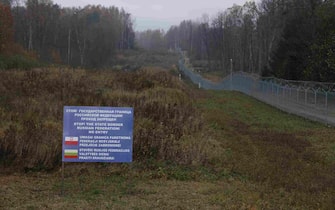 ZERDZINY, POLAND - OCTOBER 28: A warning sign stands on the Russian side next to a Lithuanian border fence near the precise point where the borders of Poland, Lithuania and the Russian semi-exclave of Kaliningrad meet as seen on October 28, 2022 near Zerdziny, Poland. The monument marks the western tip of the strategically vital Suwalki Gap, an approximately 70km long stretch of land along the Lithuanian and Polish border between Kaliningrad and Russia-loyal Belarus. Should a military conflict ever break out, Russian control of the Suwalki Gap would cut the three Baltic states of Lithuania, Latvia and Estonia off from the rest of the European Union.  (Photo by Sean Gallup/Getty Images)