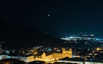 Venus and Jupiter planets in conjunction with a crescent moon rise above Piazza Duomo square in LAquila (Italy) on february 22, 2023.  (Photo by Lorenzo Di Cola/NurPhoto via Getty Images)