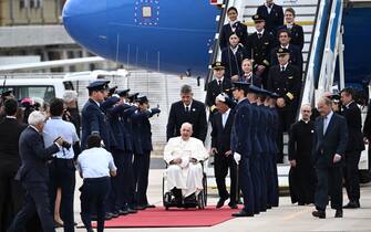 Pope Francis (C) is welcomed by Portuguese President Marcelo Rebelo de Sousa (C-R) after landing at the Figo Maduro air base in Lisbon to attend the World Youth Day (WYD) gathering of young Catholics, on August 2, 2023. Pope Francis arrived in Lisbon today to gather with a million youngsters from across the world at the World Youth Day (WYD), held as the Church reflects on its future. The 86-year-old underwent major abdominal surgery just two months ago, but that has not stopped an event-packed 42nd trip abroad, with 11 speeches and around 20 meetings scheduled. (Photo by Marco BERTORELLO / AFP) (Photo by MARCO BERTORELLO/AFP via Getty Images)