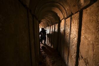 TOPSHOT - A member of the Palestinian Islamic Jihad militant group walks in a tunnel in the Gaza strip, on April 17, 2022, during a media tour amid escalating violence with Israel. - More than 20 Palestinians and Israelis were wounded in several incidents in and around Jerusalem's flashpoint Al-Aqsa Mosque complex, two days after major violence at the site. (Photo by Mahmud HAMS / AFP) (Photo by MAHMUD HAMS/AFP via Getty Images)
