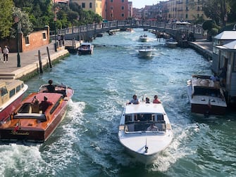 VENICE, ITALY - SEPTEMBER 30: Boats travel along a canal on September 30, 2023 in Venice, Italy. Venice is among Europe's top tourist destinations. However, recently UNESCO recommended that Venice should be put on its endangered list, claiming that too many tourists and other concerns was having a detrimental effect on the historic city. (Photo by Matt Cardy/Getty Images)