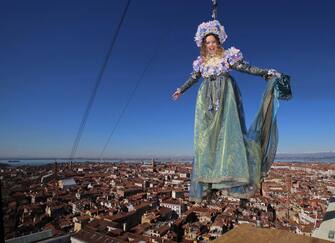 epa04097743 A handout picture released by Venice Carnival press office shows Julia Nasi, 22, prior to descend from the top of the Bell Tower to the centre of Saint Mark's Square during the traditional Volo dell' Angelo (Flight of the Angel), formerly known as Volo della Colombina (Flight of the Colombina), to open Venice Carnival in Venice's central Piazza San Marco on the Carnival's first Sunday in Venice, Italy, 23 February 2014. 

.  EPA/PRESS CARNEVALE VENEZIA HANDOUT  HANDOUT EDITORIAL USE ONLY/NO SALES/NO ARCHIVES