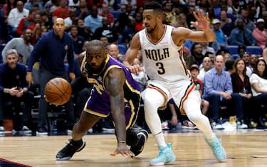 NEW ORLEANS, LOUISIANA - MARCH 27: LeBron James #6 of the Los Angeles Lakers is fouled by CJ McCollum #3 of the New Orleans Pelicans during the fourth quarter of an NBA game at Smoothie King Center on March 27, 2022 in New Orleans, Louisiana. New Orleans Pelicans won the game 116 - 108. NOTE TO USER: User expressly acknowledges and agrees that, by downloading and or using this photograph, User is consenting to the terms and conditions of the Getty Images License Agreement. (Photo by Sean Gardner/Getty Images)