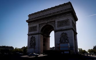 Vintage cars ride next to the Arc de Triomphe in Paris on April 17, 2022, during the 22th "TraversÃ©e of Paris in vintage vehicles" event. (Photo by Geoffroy VAN DER HASSELT / AFP) (Photo by GEOFFROY VAN DER HASSELT/AFP via Getty Images)