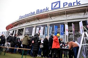 epa09608901 Fans queue for vaccination outside the Deutsche Bank Park stadium prior to the German Bundesliga soccer match between Eintracht Frankfurt and FC Union Berlin in Frankfurt, Germany, 28 November 2021. The spread of a new potentially more dangerous variant of coronavirus in southern Africa has caused international concern. Experts fear that the B.1.1.529 Coronavirus variant Omikron could be highly contagious because of an unusually large number of mutations and could also penetrate the protective shield of vaccines more easily. The National Academy of Sciences Leopoldina recommends immediate comprehensive contact restrictions in view of the dynamic corona infection incidence. These would also have to apply to vaccinated and genesis.  EPA/SASCHA STEINBACH CONDITIONS - ATTENTION: The DFL regulations prohibit any use of photographs as image sequences and/or quasi-video.