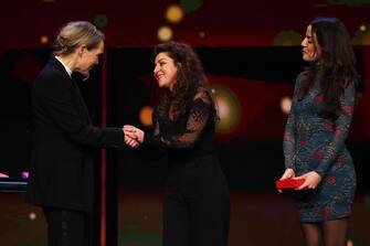 BERLIN, GERMANY - FEBRUARY 25: Isabelle Stever hands over the Golden Bear Best Short Film Award for "Les chenilles"  to Michelle Keserwany and Noel Keserwany on stage at the award ceremony of the 73rd Berlinale International Film Festival Berlin at Berlinale Palast on February 25, 2023 in Berlin, Germany. (Photo by Sebastian Reuter/Getty Images)