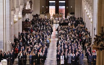 epa11763001 Guests stand as the doors to the Notre Dame de Paris cathedral open during its official reopening ceremony, in Paris, France, 07 December 2024. The Notre Dame de Paris Cathedral reopens on 07 December after nearly six years of renovation work following its destruction by a fire on 15 April 2019.  EPA/LUDOVIC MARIN / POOL  MAXPPP OUT