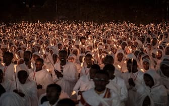 Ethiopian Orthodox worshippers hold candles as they gather to pray ahead of the Ethiopian Orthodox Christmas celebrations at the Bole Medhanialem Church in Addis Ababa on January 6, 2024. The Ethiopian Christmas, also called 'Gena' in Amharic, is celebrated on January 7. (Photo by Amanuel Sileshi / AFP) (Photo by AMANUEL SILESHI/AFP via Getty Images)
