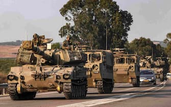 An Israeli self-propelled howitzer rolls on a highway near the southern city of Sderot on October 8, 2023. Israel's prime minister of October 8 warned of a "long and difficult" war, as fighting with Hamas left hundreds killed on both sides after a surprise attack on Israel by the Palestinian militant group. (Photo by RONALDO SCHEMIDT / AFP)