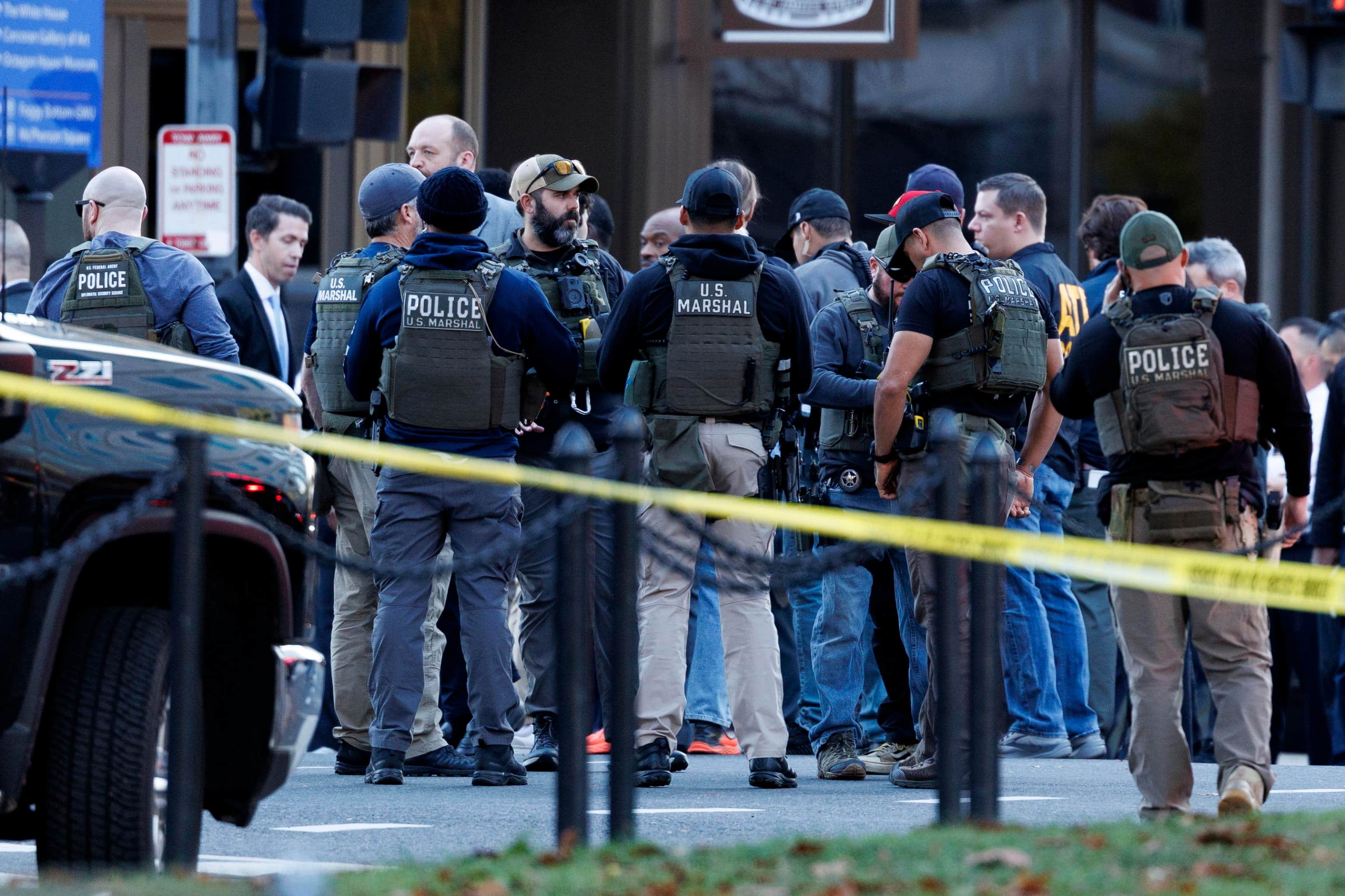 epa12551542 Law enforcement officials stand close to the scene where two West Virginia National Guard members were shot in Washington, DC, USA, 26 November 2025.  EPA/WILL OLIVER