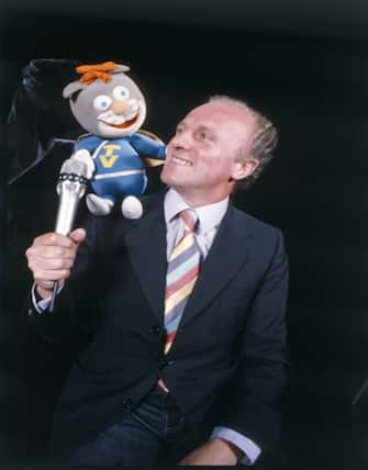 Italian TV presenter and author Maurizio Seymandi interviewing the puppet called Telegattone on his TV musical show Superclassifica Show. Milan, 1980