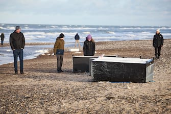 epa11044598 Locals inspect items from containers spillage  along the West coast at Tranum beach in North Jutland, Denmark, 26 December 2023. The contents of 46 lost containers from the ship Mayview Maersk wash ashore in North Jutland. The containers washed overboard during storm Pia.  EPA/Claus Bjoern Larsen  DENMARK OUT