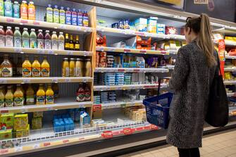 epa10468448 Customers shop for cheese and juices at Sainsbury's supermarket in London, Britain, 15 February 2023. According to the Office for National Statistics (ONS), UK's inflation rate fell for the third month in a row to 10.1 percent in January 2023, however inflation on food products is at a 45-year high with olive oil, sugar and milk prices have gone up by more than 40 percent from January 2022.  EPA/TOLGA AKMEN