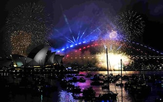 SYDNEY, AUSTRALIA - DECEMBER 31, 2023: A view of the Sydney New Year's Eve Firework show displayed three hours before midnight every year around Sydney Harbour Bridge in Sydney, Australia on December 31, 2023. There are two shows, one at 9pm and one at 12 midnight. (Photo by Jen Osborne/Anadolu via Getty Images)