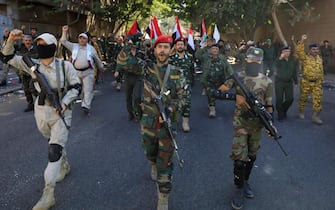 epa10915221 Houthi fighters shout slogans while marching during a military parade in solidarity with Palestinians in the Gaza Strip, in Sana'a, Yemen, 12 October 2023. The top leader of the Houthis movement, Abdul-Malik al-Houthi, has warned that his movement will stand ready to engage in hostilities against Israel should the United States directly back the Israeli military campaign on the Gaza Strip. Thousands of Israelis and Palestinians have died since the militant group Hamas launched an unprecedented attack on Israel from the Gaza Strip on 07 October 2023, leading to Israeli retaliation strikes on the Palestinian enclave.  EPA/YAHYA ARHAB