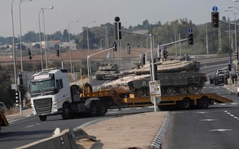 epa10907770 Israeli army transports tanks toward border with Gaza, 08 October 2023. Israel announced initiating a large-scale operation 'Swords of Iron' after surprise attacks on Israel on 07 October claimed by the Islamist movement Hamas killed more than 670 Israelis and left over 2,100 injured in the attacks, the Israeli army said 08 October.  EPA/ATEF SAFADI